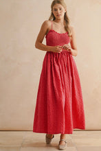 Load image into Gallery viewer, Woman wearing a red checkered dress against a beige background