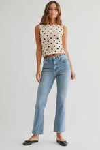 Load image into Gallery viewer, Woman wearing a polka dot top and light blue jeans on a white background