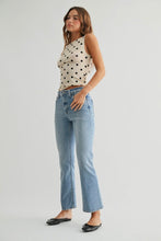 Load image into Gallery viewer, Woman wearing a polka dot top and blue jeans on a plain background