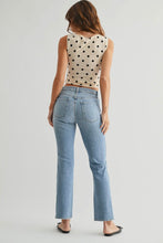 Load image into Gallery viewer, Woman wearing a polka dot top and light blue jeans on a plain background
