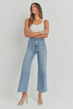 Load image into Gallery viewer, Woman wearing light blue jeans and a white top on a plain background