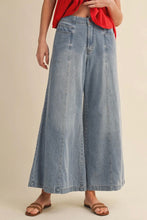 Load image into Gallery viewer, Person wearing a red top and blue denim wide-leg pants on a beige background