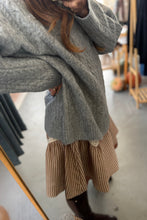 Load image into Gallery viewer, Person wearing a gray sweater and beige skirt in a store setting