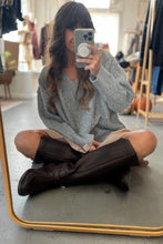 Load image into Gallery viewer, Person sitting on the floor taking a mirror selfie wearing a gray sweater and brown boots.