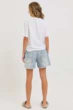 Load image into Gallery viewer, Person wearing a white t-shirt and light blue denim shorts on a plain background