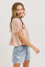 Load image into Gallery viewer, Woman wearing a light pink blouse and denim shorts on a white background