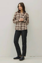 Load image into Gallery viewer, Woman wearing a plaid shirt and dark jeans against a white background
