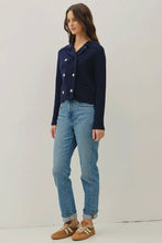 Load image into Gallery viewer, Woman wearing a navy jacket and blue jeans on a plain background