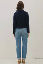 Load image into Gallery viewer, Person wearing a navy sweater and light blue jeans on a plain background