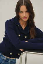 Load image into Gallery viewer, Woman wearing a navy blue coat with gold buttons against a plain background