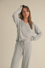 Load image into Gallery viewer, Woman wearing a gray pajama set against a beige background