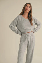 Load image into Gallery viewer, Woman wearing a gray lounge set against a beige background