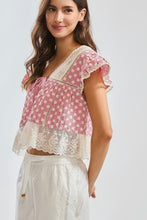 Load image into Gallery viewer, Woman wearing a red and white patterned top with lace details on a plain background