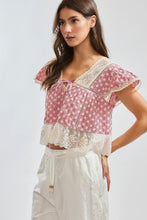 Load image into Gallery viewer, Woman wearing a red and white patterned top with lace details on a white background