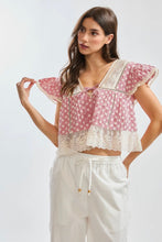 Load image into Gallery viewer, Woman wearing a floral top and white pants on a plain background