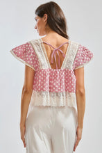 Load image into Gallery viewer, Woman wearing a red and white patterned top with lace details on a plain background