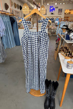 Load image into Gallery viewer, Black and white checkered dress on a mannequin in a store setting with jeans and shoes.