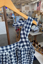 Load image into Gallery viewer, Blue and white checkered shirt on a hanger with a store interior in the background