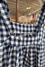 Load image into Gallery viewer, Navy and white checkered shirt on a hanger with blurred indoor background