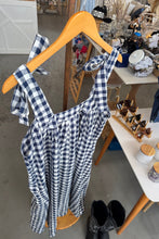 Load image into Gallery viewer, Blue and white checkered dress on a wooden hanger with a blurred store background