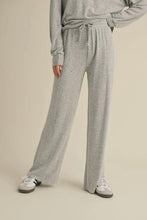 Load image into Gallery viewer, Person wearing gray sweatpants and a matching top on a beige background