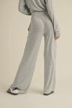 Load image into Gallery viewer, Person wearing gray sweatpants on a beige background
