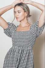 Load image into Gallery viewer, Woman wearing a black and white checkered dress with a plain background