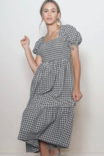 Load image into Gallery viewer, Woman wearing a black and white checkered dress against a plain background