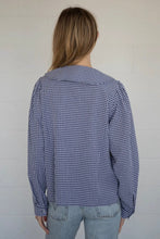 Load image into Gallery viewer, Person wearing a blue and white checkered shirt against a plain background