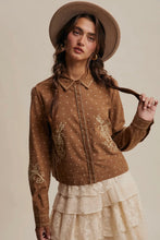 Load image into Gallery viewer, Woman wearing a brown embroidered blouse and beige hat against a neutral background