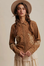 Load image into Gallery viewer, Woman wearing a brown embroidered shirt and beige hat against a neutral background