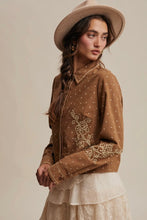 Load image into Gallery viewer, Woman wearing a brown embroidered blouse and beige hat against a plain background