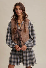 Load image into Gallery viewer, Woman wearing a plaid dress with a brown vest against a neutral background