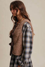Load image into Gallery viewer, Woman wearing a plaid shirt and brown vest against a neutral background
