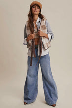 Load image into Gallery viewer, Woman wearing a plaid shirt, vest, and wide-leg jeans with a beige background