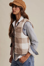 Load image into Gallery viewer, Woman wearing a plaid vest over a denim shirt with a beige cap on a neutral background