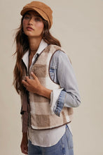 Load image into Gallery viewer, Woman wearing a checkered vest, denim jacket, and cap against a neutral background
