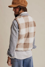 Load image into Gallery viewer, Person wearing a plaid vest over a denim shirt with a beige background