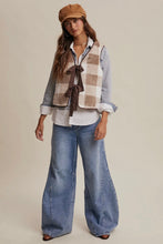 Load image into Gallery viewer, Woman wearing a plaid vest, white shirt, and blue jeans with a beige cap on a beige background