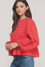 Load image into Gallery viewer, Woman wearing a red blouse and blue jeans on a white background