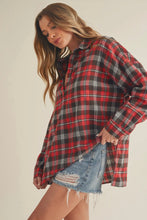 Load image into Gallery viewer, Woman wearing a red and black plaid shirt with denim shorts on a beige background
