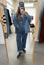 Load image into Gallery viewer, Person wearing a denim outfit with a cap in a clothing store.