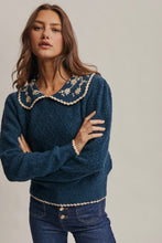 Load image into Gallery viewer, Woman wearing a blue sweater with decorative collar and buttons on a plain background