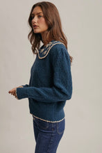 Load image into Gallery viewer, Woman wearing a blue sweater with lace details on a plain background