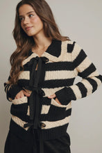 Load image into Gallery viewer, Woman wearing a black and white striped sweater with a tie detail on a plain background