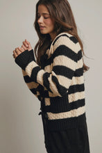 Load image into Gallery viewer, Woman wearing a black and beige striped sweater against a plain background