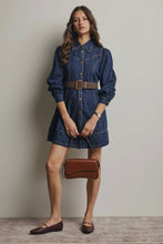Load image into Gallery viewer, Woman wearing a denim dress with a brown belt and holding a brown handbag against a plain background