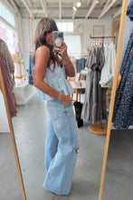Load image into Gallery viewer, Woman taking a mirror selfie wearing a light blue dress and jeans in a clothing store.
