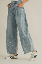 Load image into Gallery viewer, Light blue jeans with decorative studs worn by a person on a plain background