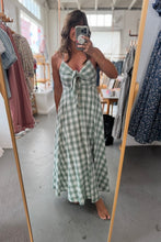 Load image into Gallery viewer, Person wearing a green checkered dress in a clothing store.